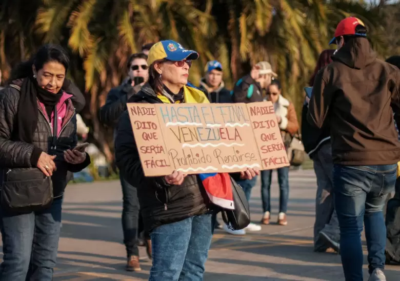 Mujer sostiene una pancarta en apoyo a Venezuela durante una manifestacin, exigiendo libertad y el fin de la represin en el pas.